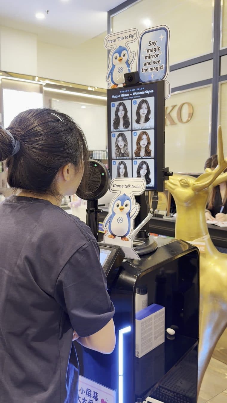 A tester picks a hairstyle on the touch screen