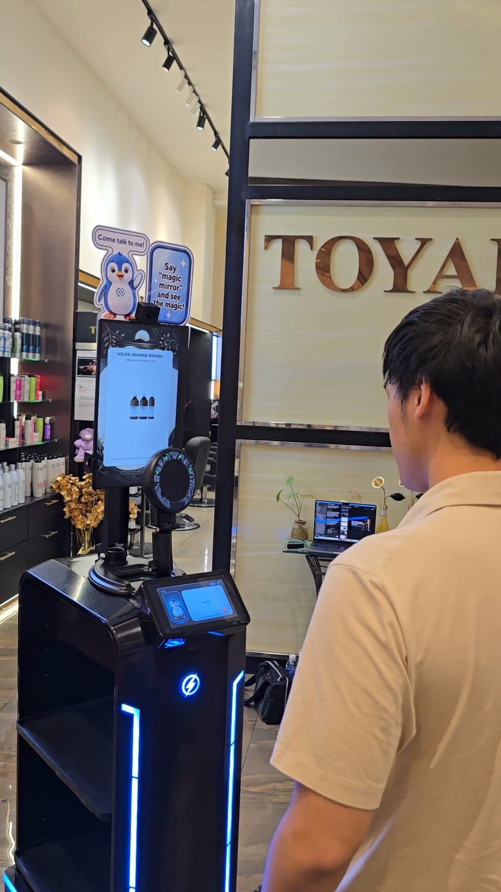 A person stops to talk to Pip in the Toyako salon