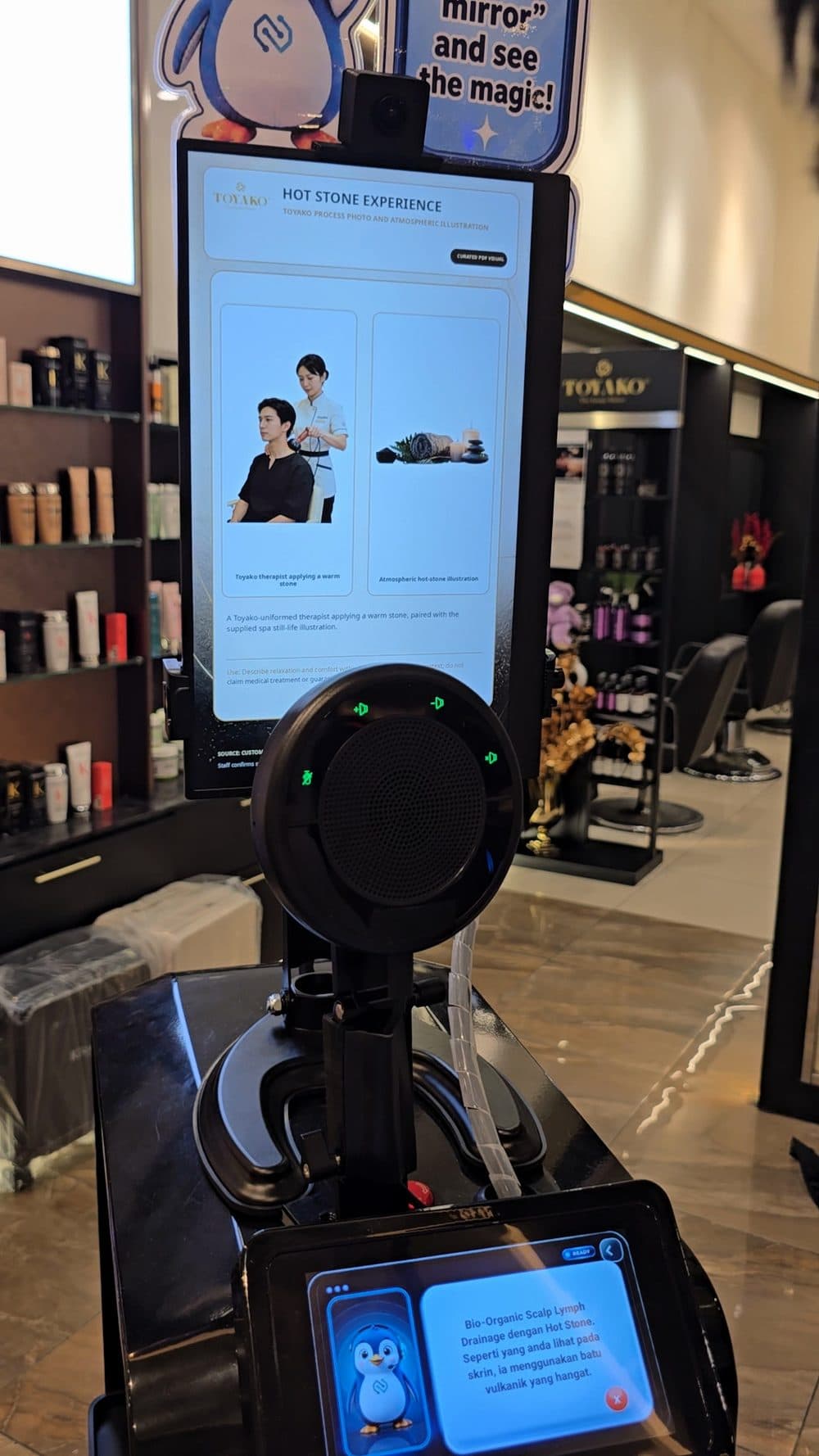 Pip explaining a salon service on FL1's screen at the Toyako salon
